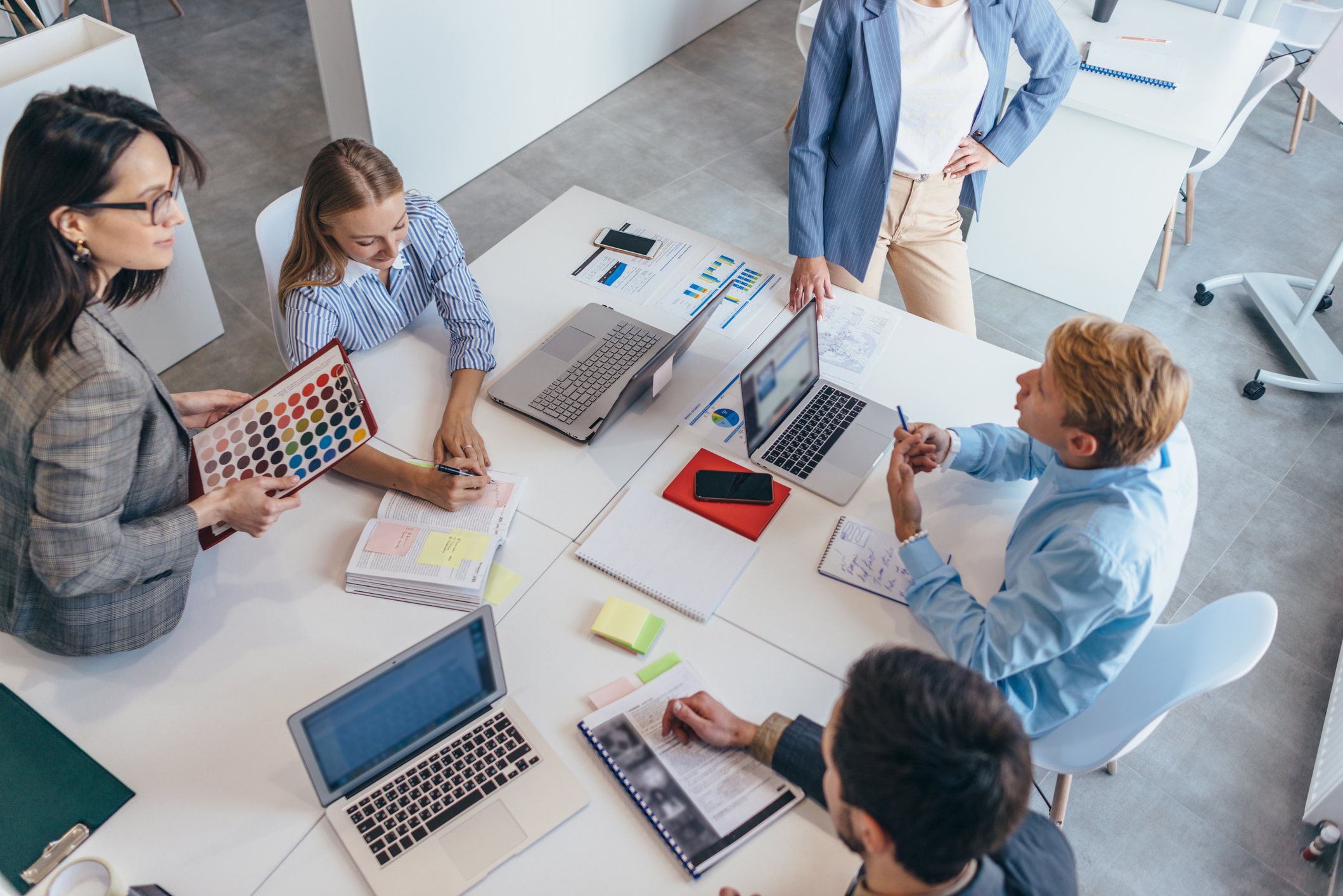 Group of people sitting in office working together on a project