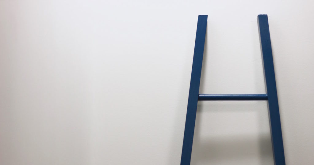 White wall and blue ladder at Roam Innovative Workplace