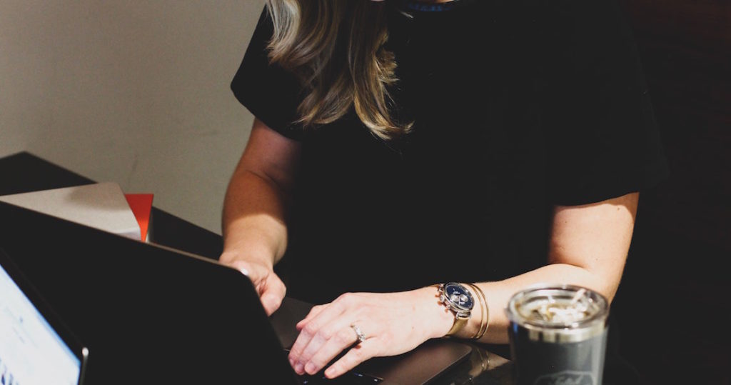 woman typing on computer