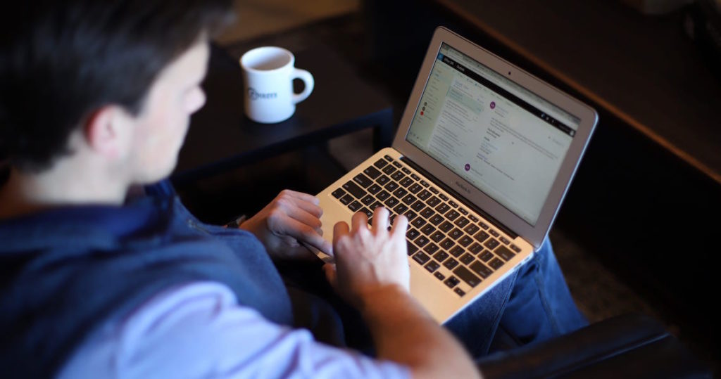 Man typing on laptop computer