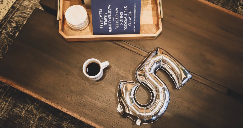 Coffee mug and silver foil balloon on coffee table