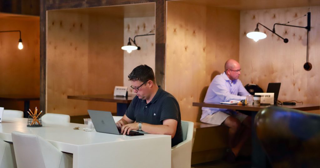 Members working in shared space at Roam