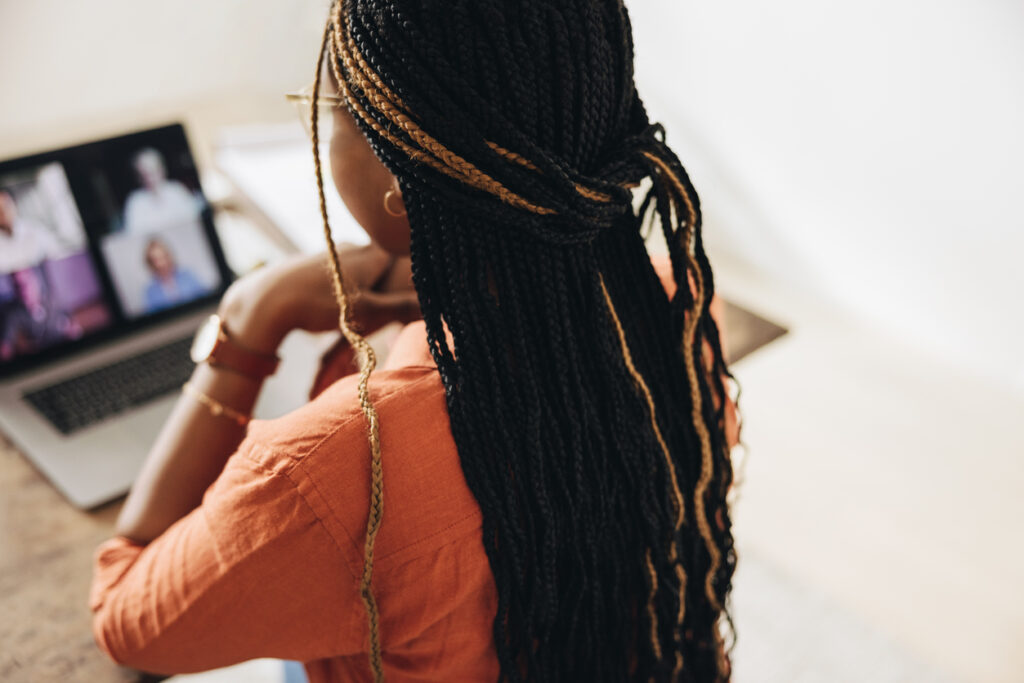 Creative young woman attending a virtual meeting