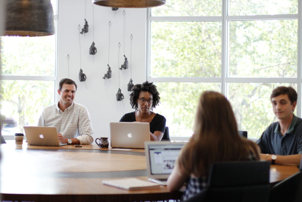 people speaking at a round table
